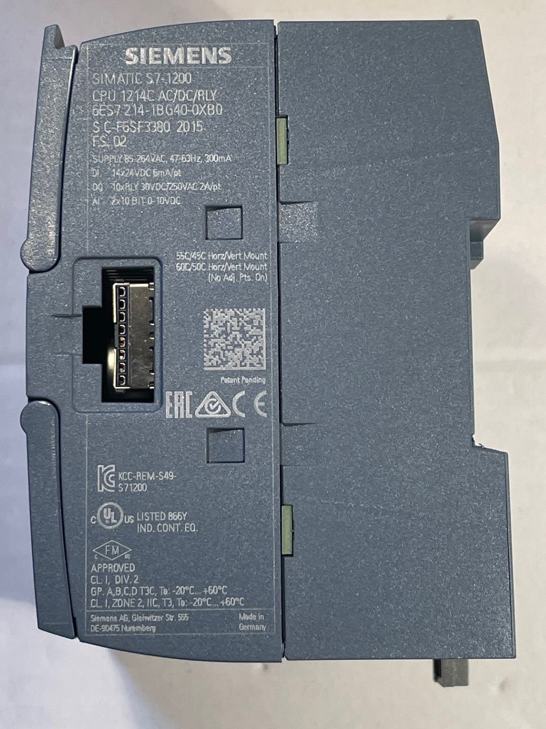 A Siemens SIMATIC S7 1200 CPU module, model CPU 1214 AC/DC DR/Y DR, part number 6FG57390 2015, shown from the back side with the connector terminal block visible.