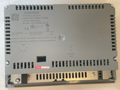 A Siemens industrial electronic module, model 6TF600 647-0A811-3AX0, photographed from the bottom side showing the printed technical specifications and a small red 'TESTED' sticker.