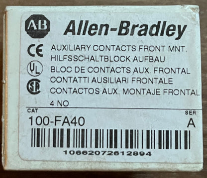 A small Allen-Bradley electrical component box labeled '100-FA40' with a barcode, placed on a brown wooden surface.